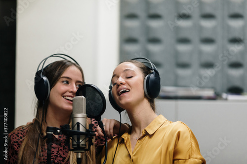 Two women singing at sutdio photo