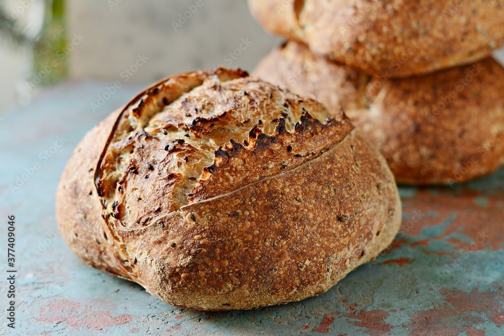 Homemade Freshly Baked Country Bread made from wheat and whole grain flour on gray background. French Freshly baked bread. Homemade Freshly Baked Country Bread made from wheat and whole grain flour on gray background. French Freshly baked bread.