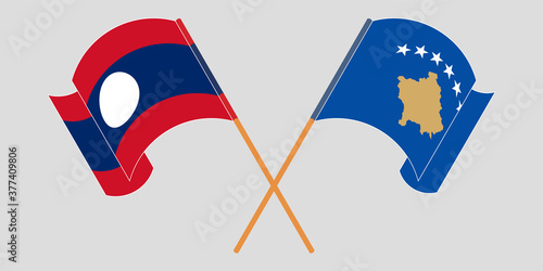Crossed and waving flags of Kosovo and Laos