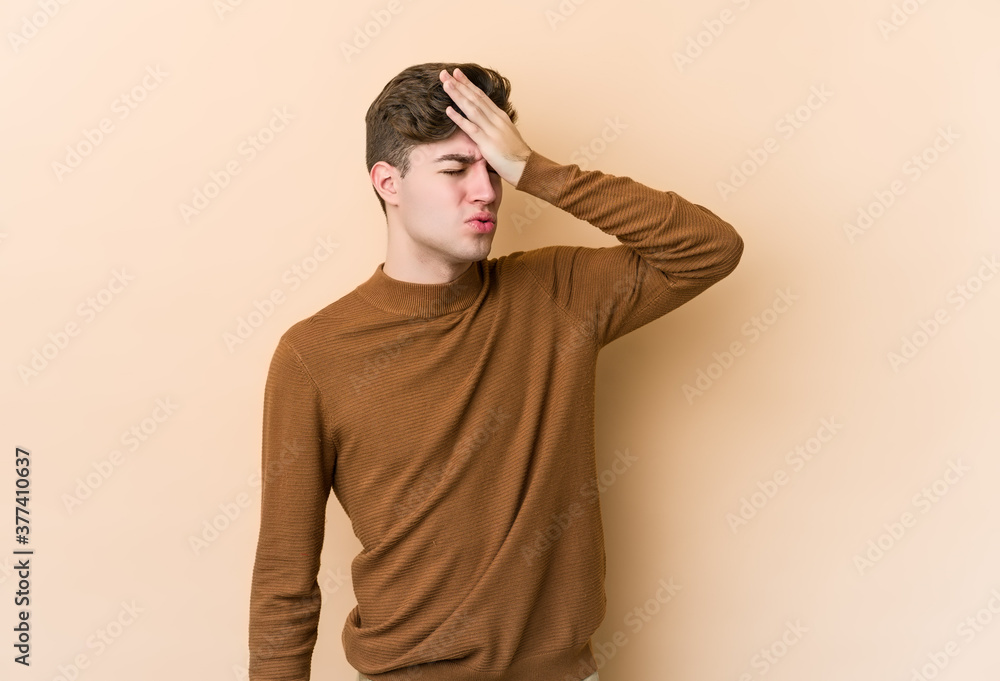 Young caucasian man isolated on beige background forgetting something, slapping forehead with palm and closing eyes. Young caucasian man isolated on beige background forgetting something, slapping forehead with palm and closing eyes.
