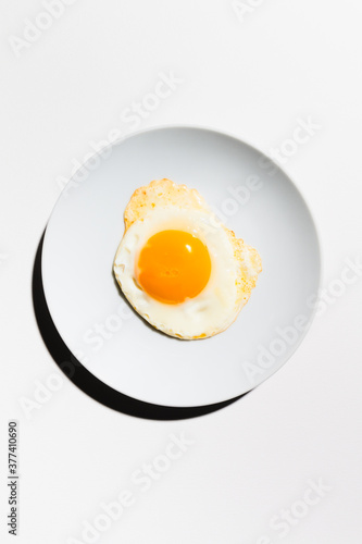 Fried egg on a plate overhead view photo