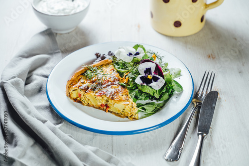 Food: Red lentil tart with savage salad and edible flowers