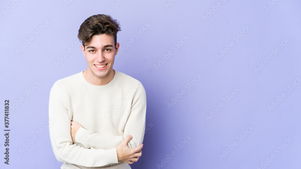 Young caucasian man isolated on purple background laughing and having fun. Young caucasian man isolated on purple background laughing and having fun.
