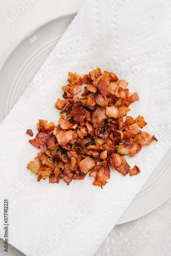 Diced bacon on a paper towel used to soak up extra grease