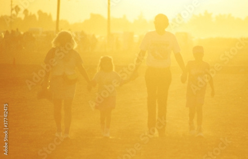 happy family walking in the sunshine © Brent