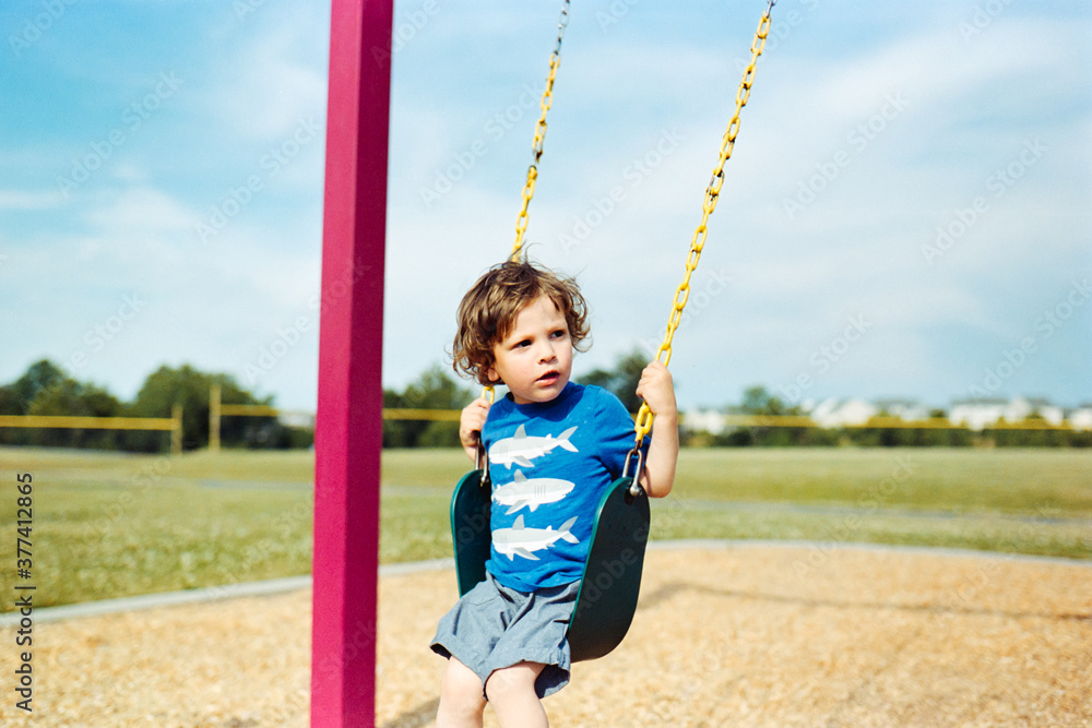 Expressive boy on swings portrait Expressive boy on swings portrait