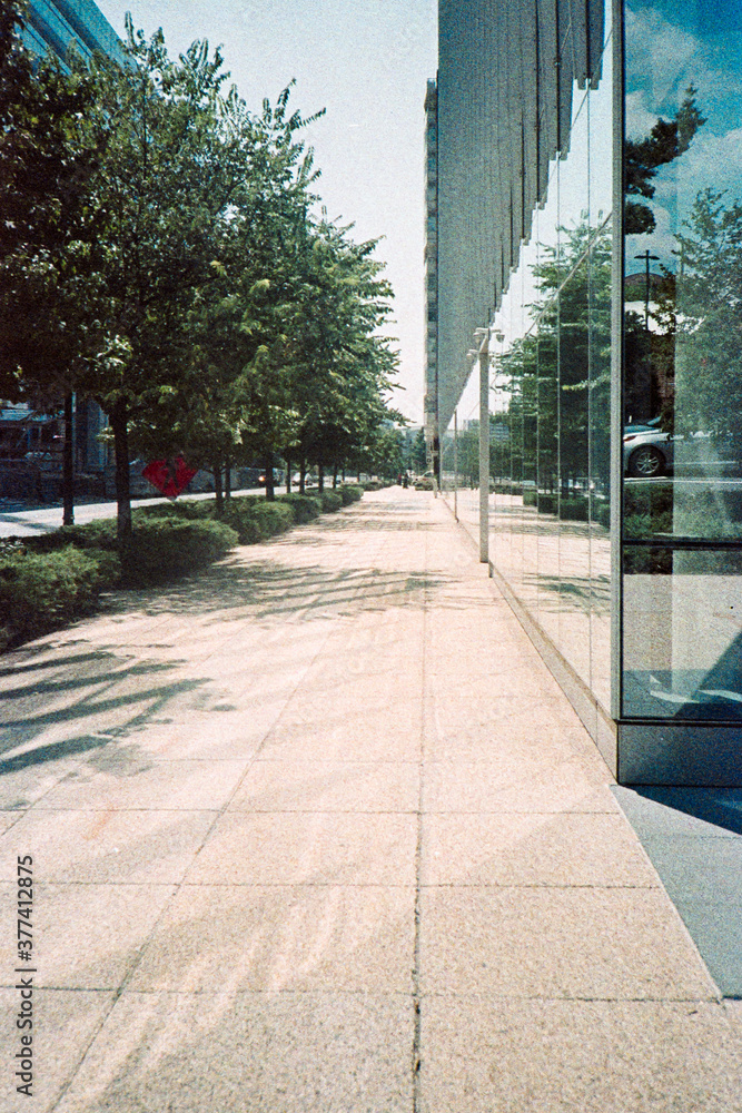 Glass architecture reflecting on the sidewalk Glass architecture reflecting on the sidewalk