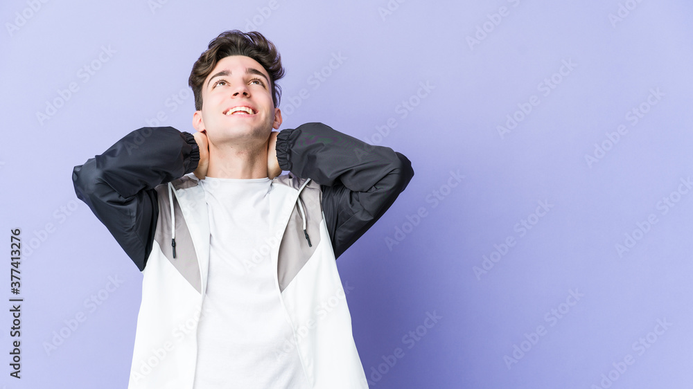 Young caucasian man isolated on purple background feeling confident, with hands behind the head. Young caucasian man isolated on purple background feeling confident, with hands behind the head.