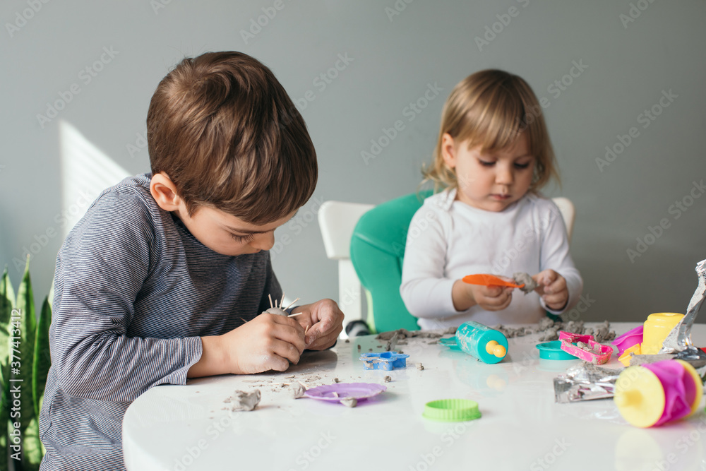 Siblings Playing with Modeling Clay at Home Siblings Playing with Modeling Clay at Home