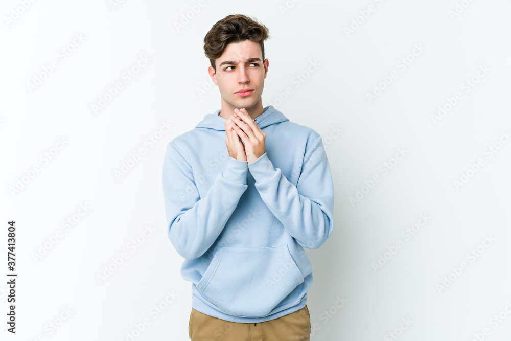 Young caucasian man isolated on white background making up plan in mind, setting up an idea. Young caucasian man isolated on white background making up plan in mind, setting up an idea.