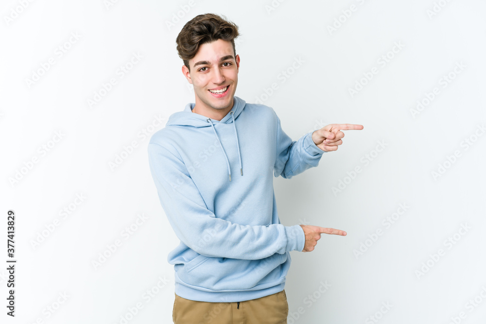 Young caucasian man isolated on white background excited pointing with forefingers away. Young caucasian man isolated on white background excited pointing with forefingers away.