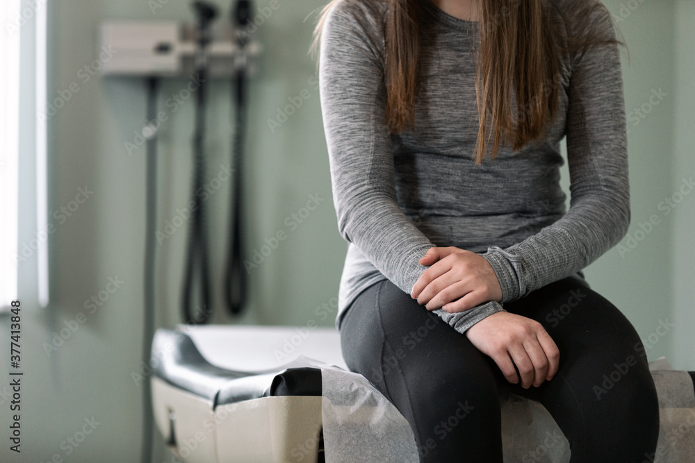 Exam: Anonymous Teen Girl Sits On Exam Table Waiting For Physician Exam: Anonymous Teen Girl Sits On Exam Table Waiting For Physician