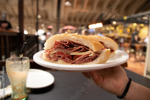 Traditional mortadella sandwich from Mercado Municipal (Municipal Market) in Sao Paulo, Brazil. bologna snack. Bread with sliced ​​pork.