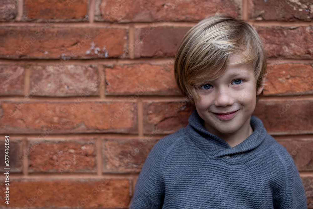 Happy young blond boy laughing at the camera Happy young blond boy laughing at the camera