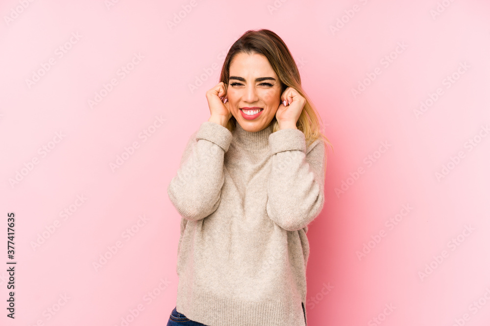 Middle age woman over isolated background covering ears with hands. Middle age woman over isolated background covering ears with hands.