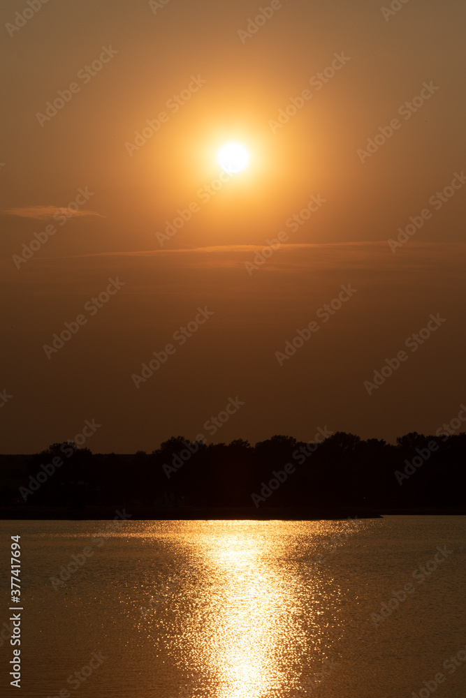 Wildfire smoke sunset on a lake 