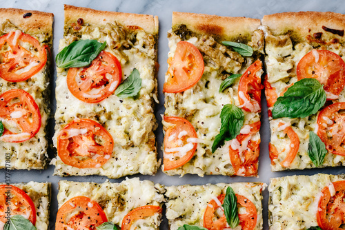 Sliced pesto, tomato and basil flatbread