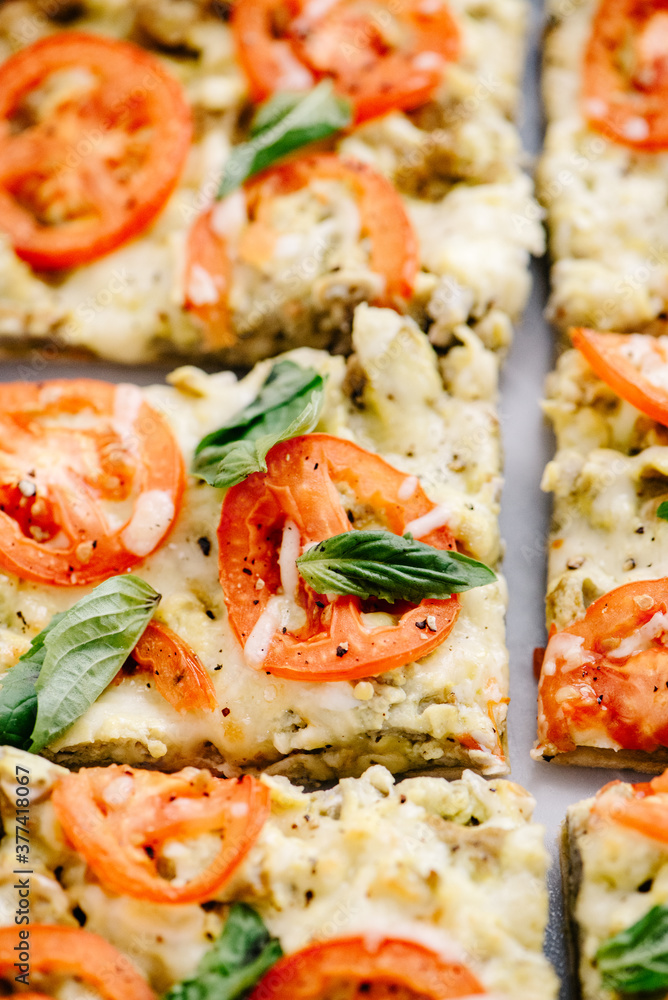 Sliced pesto, tomato and basil flatbread Sliced pesto, tomato and basil flatbread