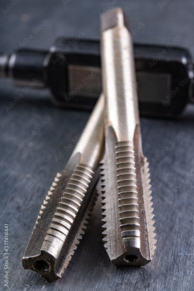 Naklejka premium Metal thread cutting tools. Tool steel accessories for locksmiths.