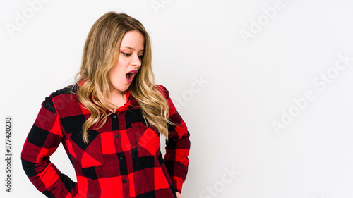 Young cauciasian woman isolated on white background being shocked because of something she has seen. photo