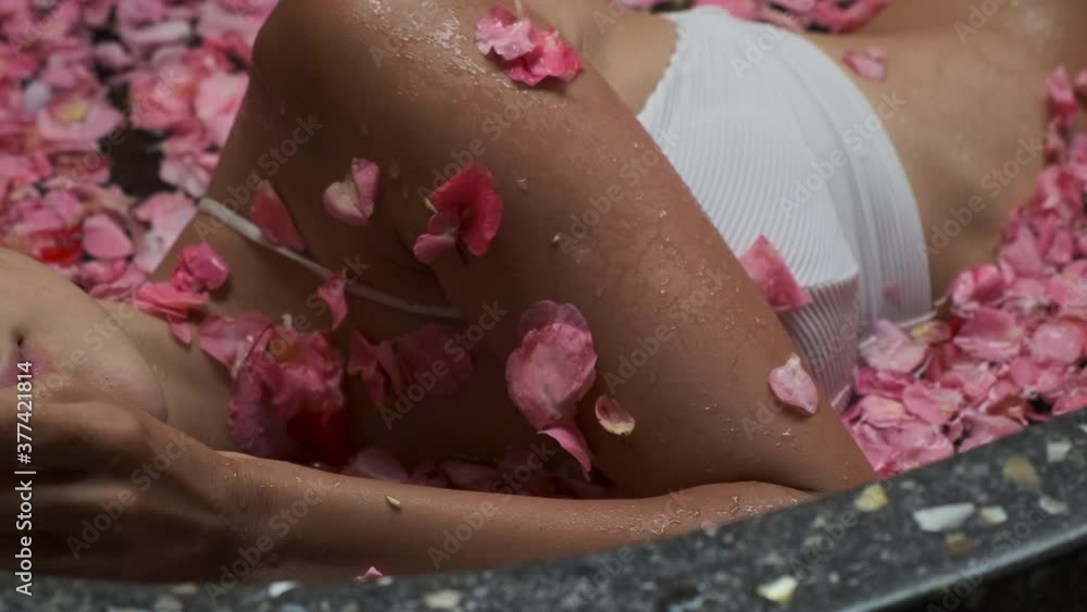 woman is relaxing in floral bath in spa salon woman is relaxing in floral bath in spa salon
