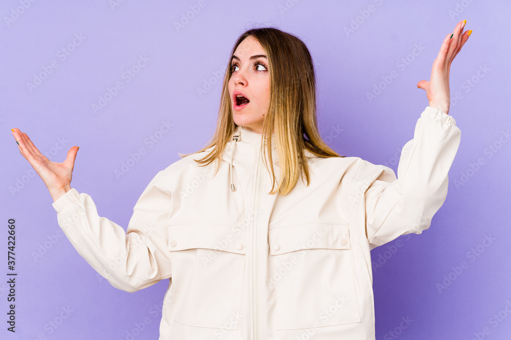 Young caucasian woman isolated on purple background screaming to the sky, looking up, frustrated. Young caucasian woman isolated on purple background screaming to the sky, looking up, frustrated.