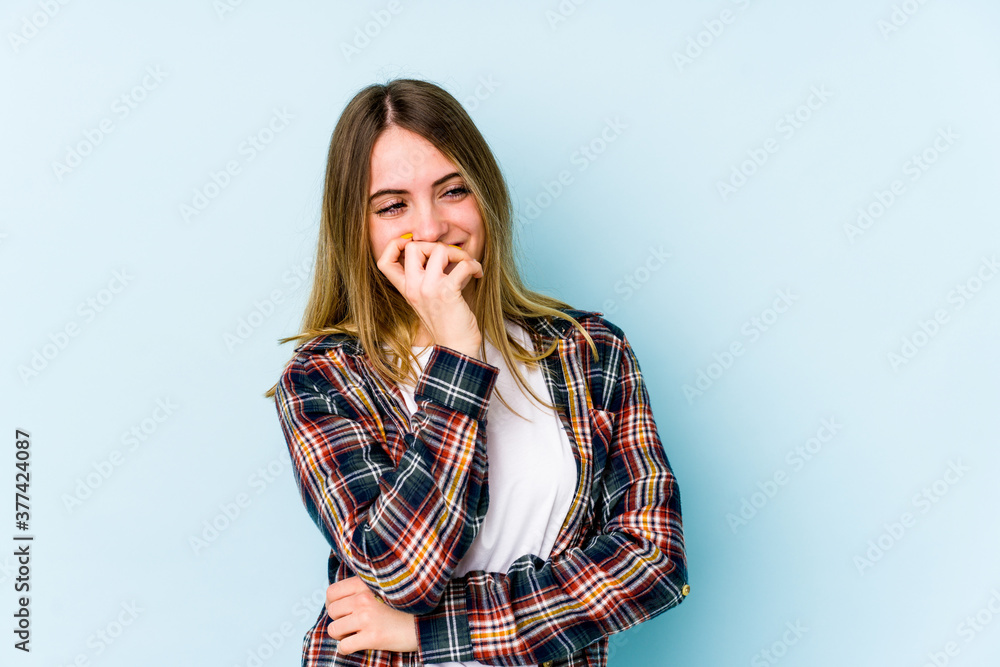 Young caucasian woman isolated on blue background laughing happy, carefree, natural emotion. Young caucasian woman isolated on blue background laughing happy, carefree, natural emotion.