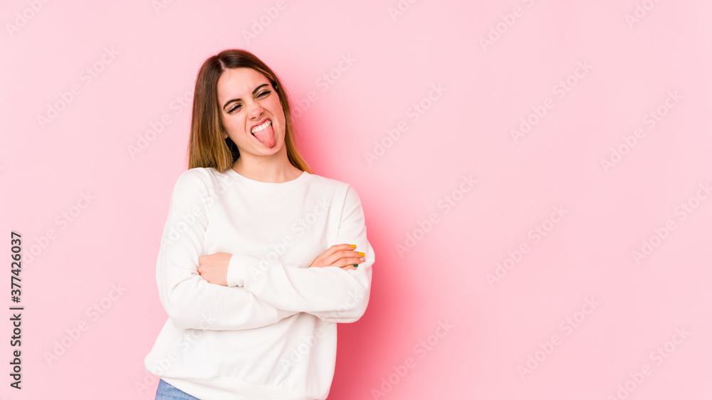 Young caucasian woman isolated on pink background funny and friendly sticking out tongue. Young caucasian woman isolated on pink background funny and friendly sticking out tongue.