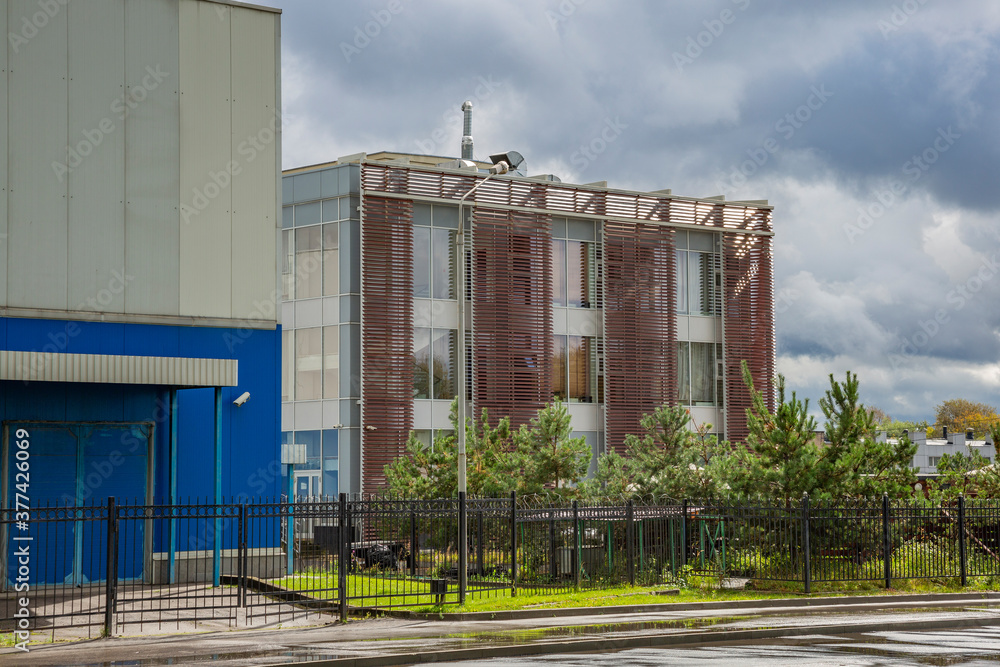 Panel building for industrial or warehouse use against the backdrop of a dramatic sky