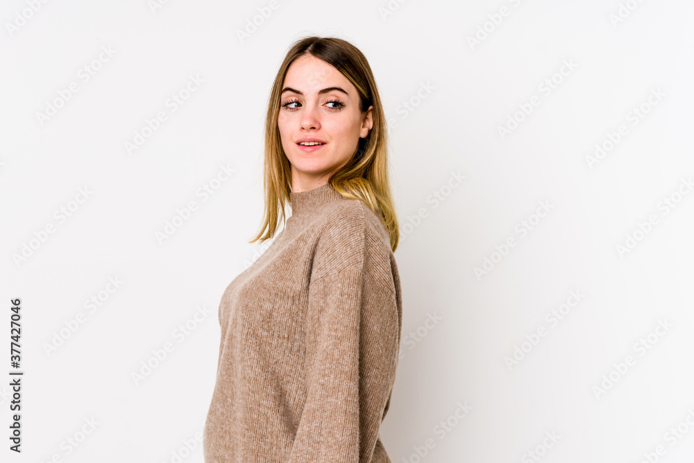 Young caucasian woman isolated on white background looks aside smiling, cheerful and pleasant. Young caucasian woman isolated on white background looks aside smiling, cheerful and pleasant.
