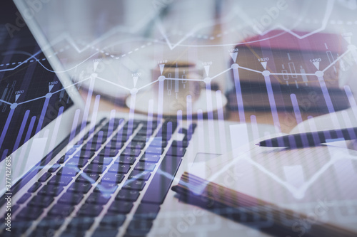 Double exposure of financial chart drawing and desktop with coffee and items on table background. Concept of forex market trading