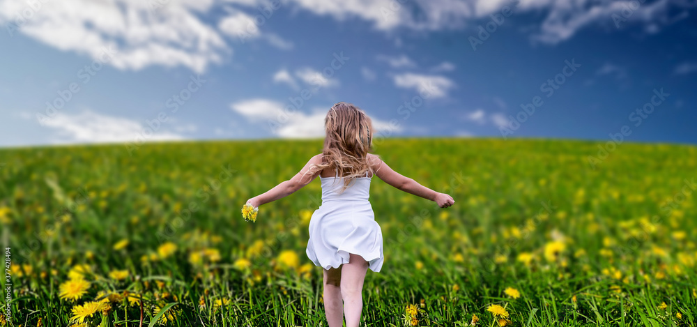 a girl with wide open hands in a yellow flower field. a girl with wide open hands in a yellow flower field.