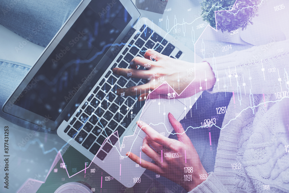 Double exposure of woman hands working on computer and forex chart hologram drawing. Top View. Financial analysis concept. Double exposure of woman hands working on computer and forex chart hologram drawing. Top View. Financial analysis concept.
