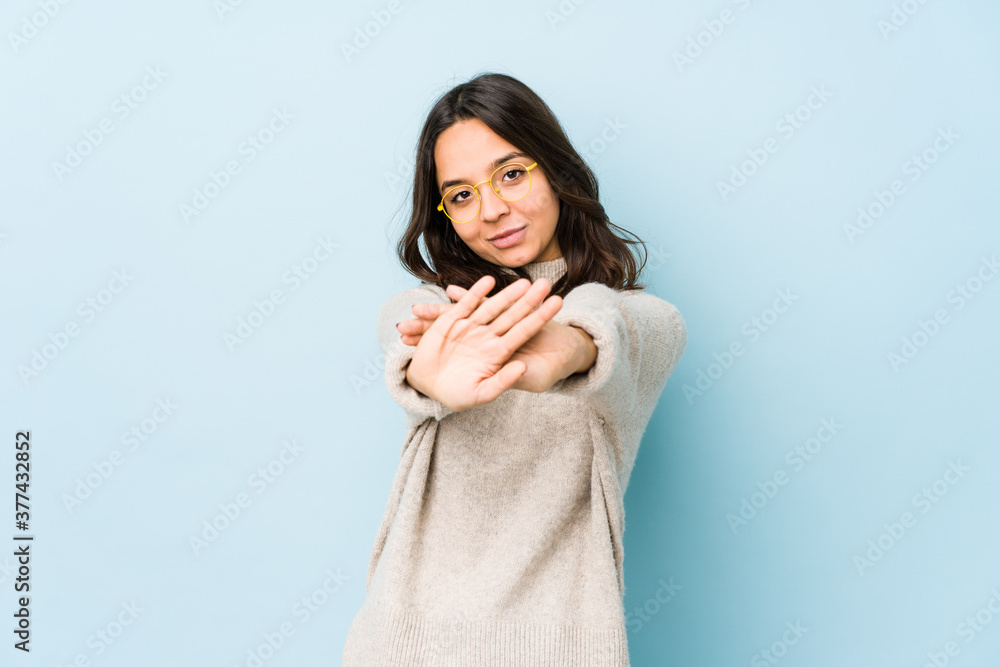 Young mixed race hispanic woman isolated standing with outstretched hand showing stop sign, preventing you. Young mixed race hispanic woman isolated standing with outstretched hand showing stop sign, preventing you.