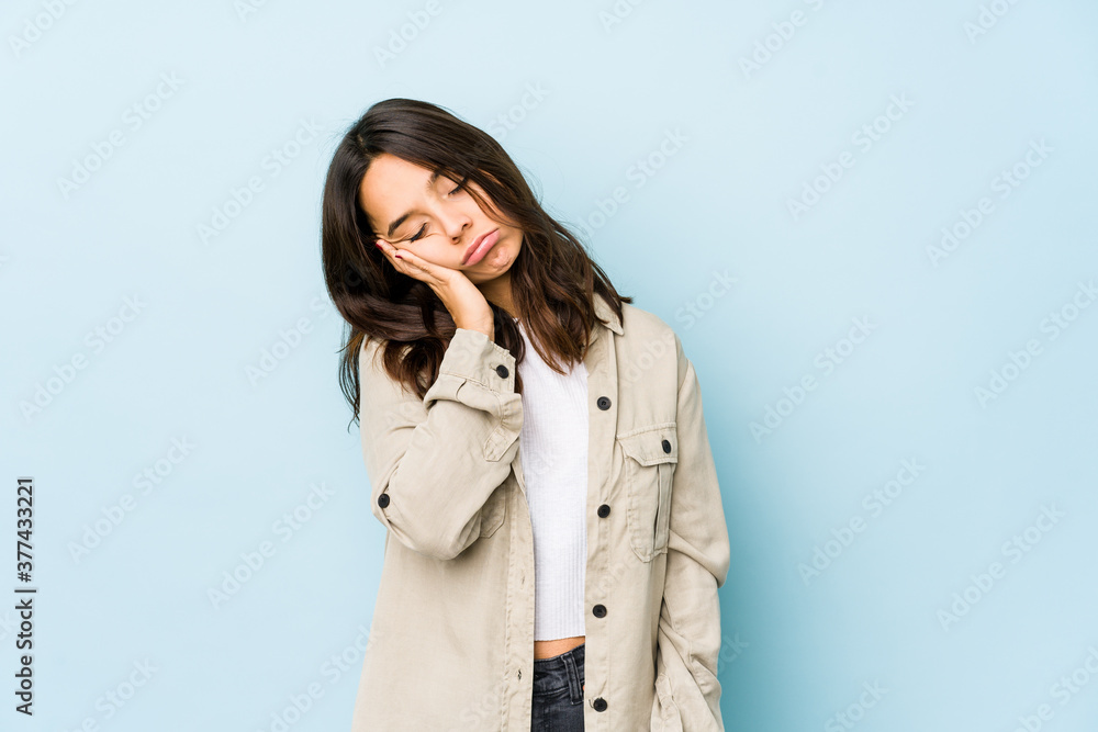 Young mixed race hispanic woman isolated who is bored, fatigued and need a relax day. Young mixed race hispanic woman isolated who is bored, fatigued and need a relax day.