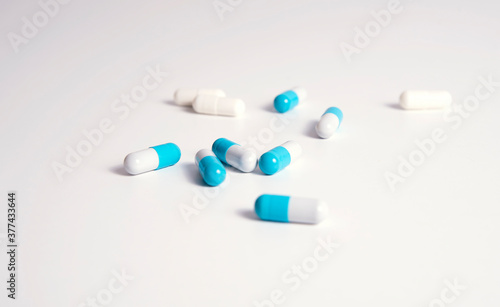 White and bleu medical pills on white background