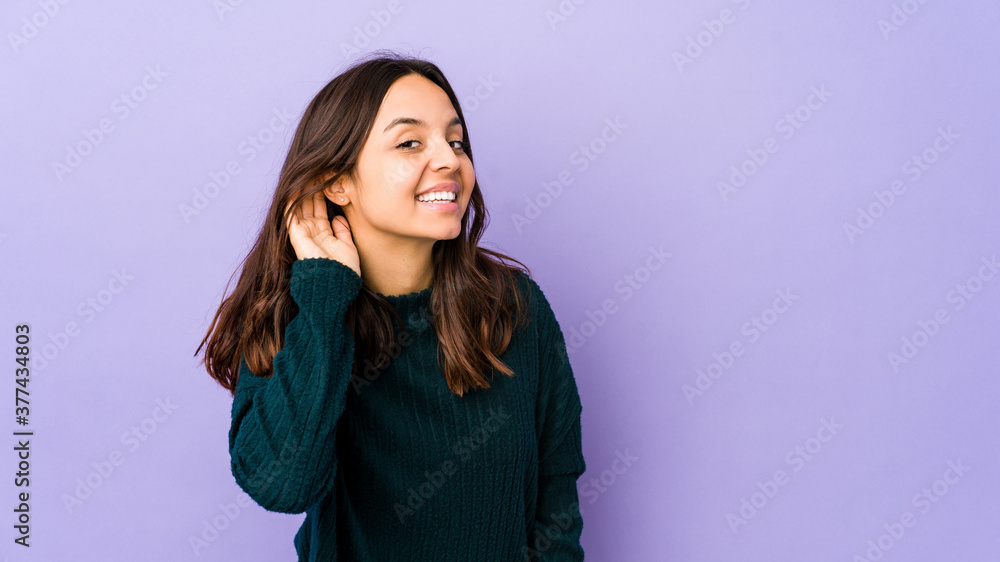 Young mixed race hispanic woman isolated trying to listening a gossip. Young mixed race hispanic woman isolated trying to listening a gossip.