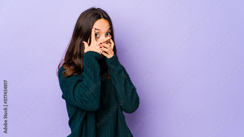 Young mixed race hispanic woman isolated blink through fingers frightened and nervous. Young mixed race hispanic woman isolated blink through fingers frightened and nervous.