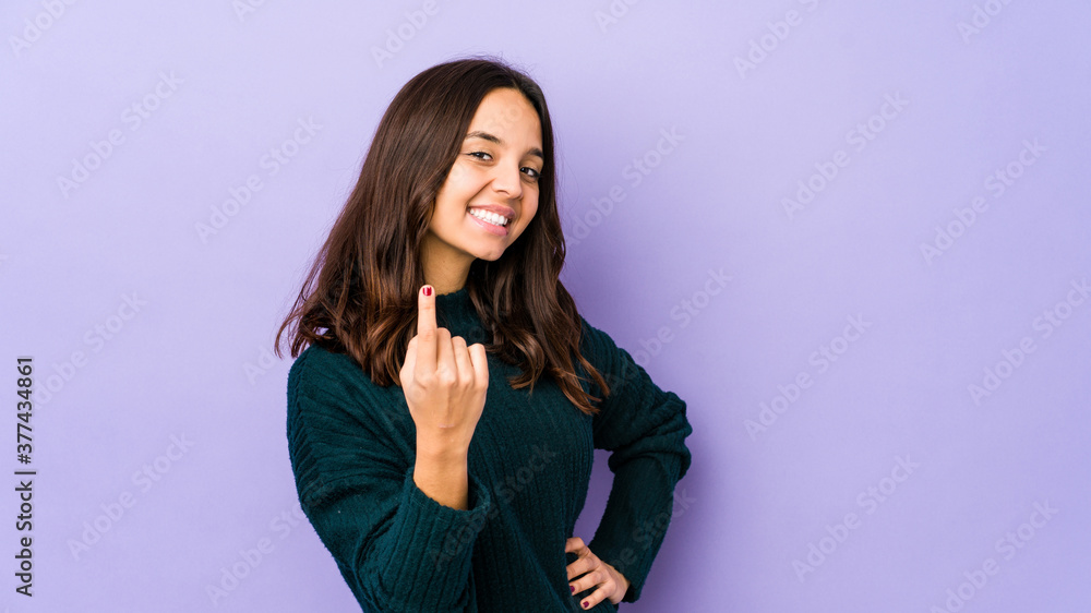 Young mixed race hispanic woman isolated pointing with finger at you as if inviting come closer. Young mixed race hispanic woman isolated pointing with finger at you as if inviting come closer.