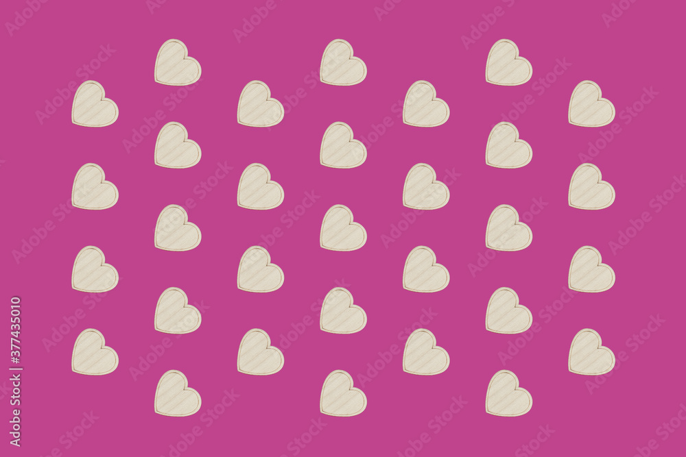 Wooden hearts on wooden on pink background, flat lay, top view. Concept of love, valentines, congratulations