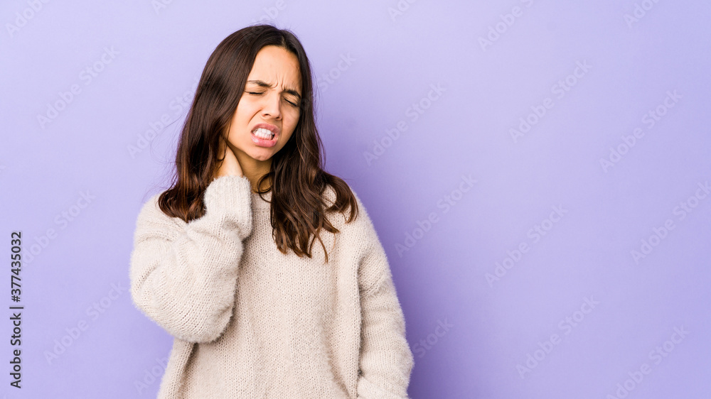 Young mixed race hispanic woman isolated having a neck pain due to stress, massaging and touching it with hand. Young mixed race hispanic woman isolated having a neck pain due to stress, massaging and touching it with hand.