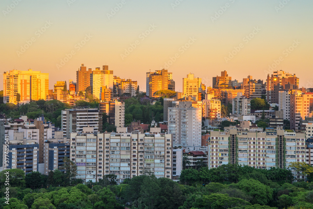 Porto Alegre skyline during sunrise with buildings partially illuminated. City located in the South of Brazil. 