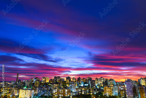 Slika na platnu Dramatic sky with clouds after sunset with Porto Alegre, Brazil skyline in the bottom of the frame