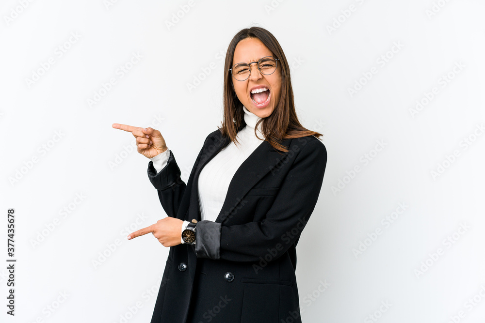 Young mixed race business woman isolated on white background pointing with forefingers to a copy space, expressing excitement and desire. Young mixed race business woman isolated on white background pointing with forefingers to a copy space, expressing excitement and desire.