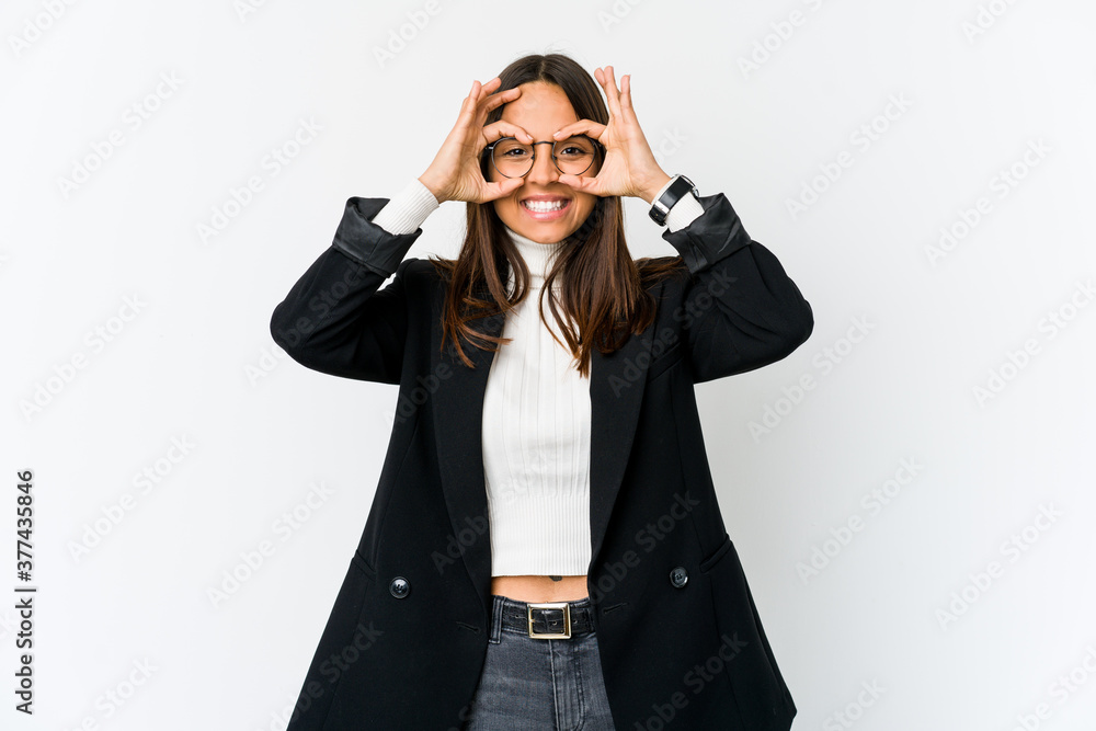 Young mixed race business woman isolated on white background showing okay sign over eyes Young mixed race business woman isolated on white background showing okay sign over eyes