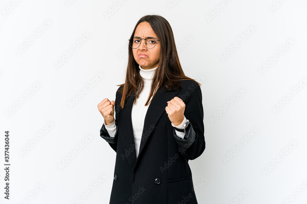 Young mixed race business woman isolated on white background showing fist to camera, aggressive facial expression. Young mixed race business woman isolated on white background showing fist to camera, aggressive facial expression.