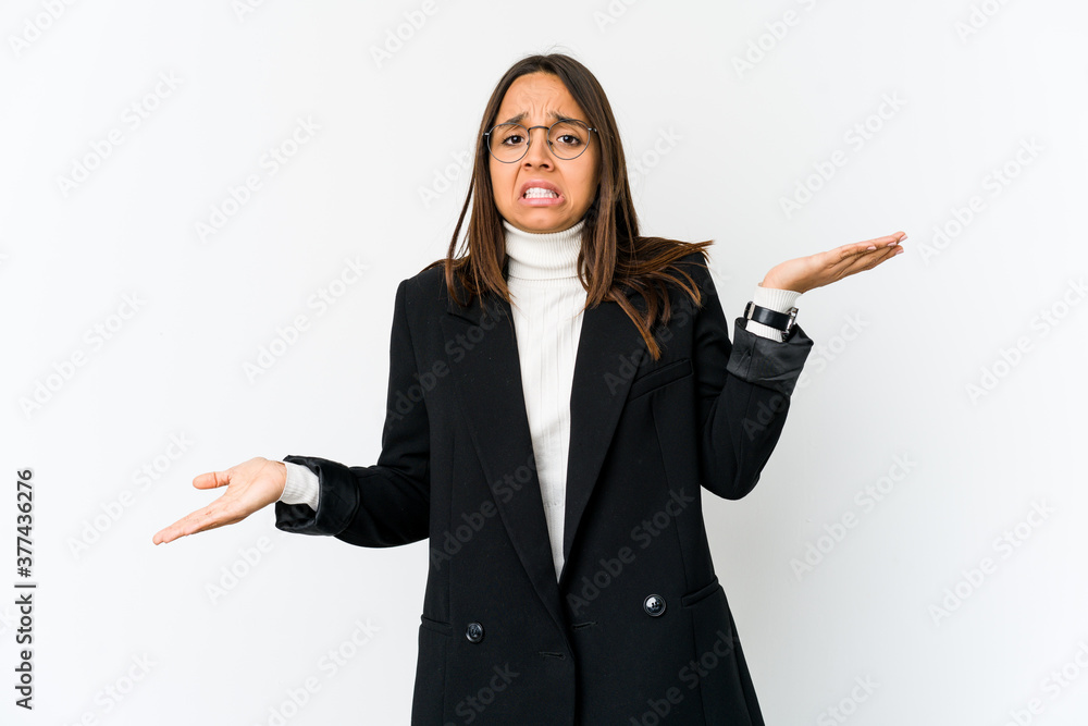 Young mixed race business woman isolated on white background confused and doubtful shrugging shoulders to hold a copy space. Young mixed race business woman isolated on white background confused and doubtful shrugging shoulders to hold a copy space.