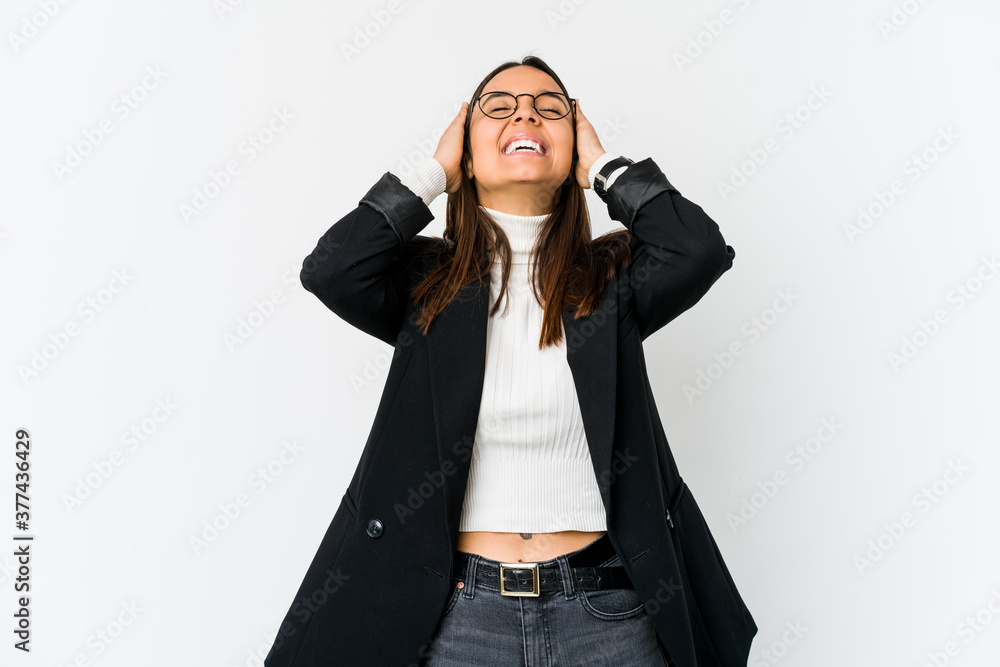 Young mixed race business woman isolated on white background laughs joyfully keeping hands on head. Happiness concept. Young mixed race business woman isolated on white background laughs joyfully keeping hands on head. Happiness concept.