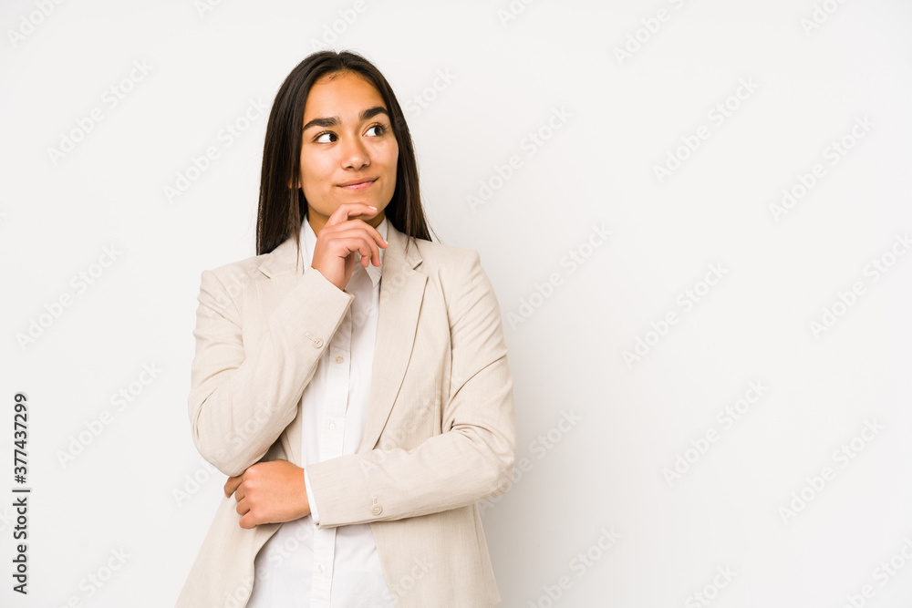 Young woman isolated on a white background looking sideways with doubtful and skeptical expression. Young woman isolated on a white background looking sideways with doubtful and skeptical expression.