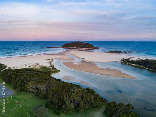 Photography Coastal scene at dusk forest running down to empty sandy beach